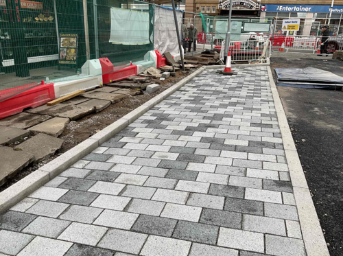 A photo of the completed grey paving tiles on the loading bay part on King Street
