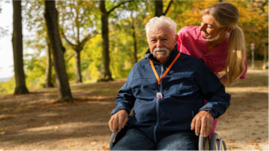 man in wheelchair with woman behind him
