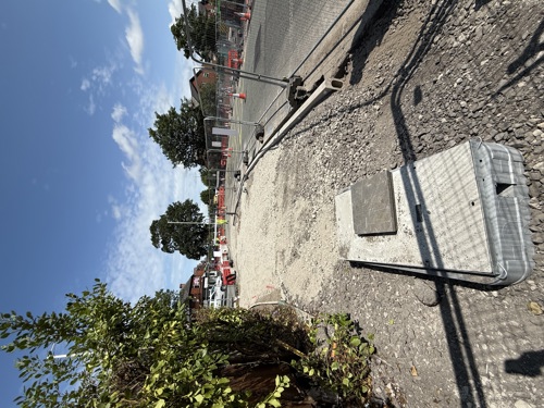 A dug up pavement, with a drain installed. The pavement will come soon.