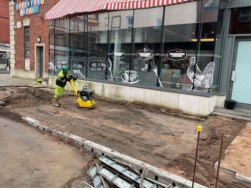 A progress picture of Market Street, a workman is using a machine to compressing the earth - January 2025